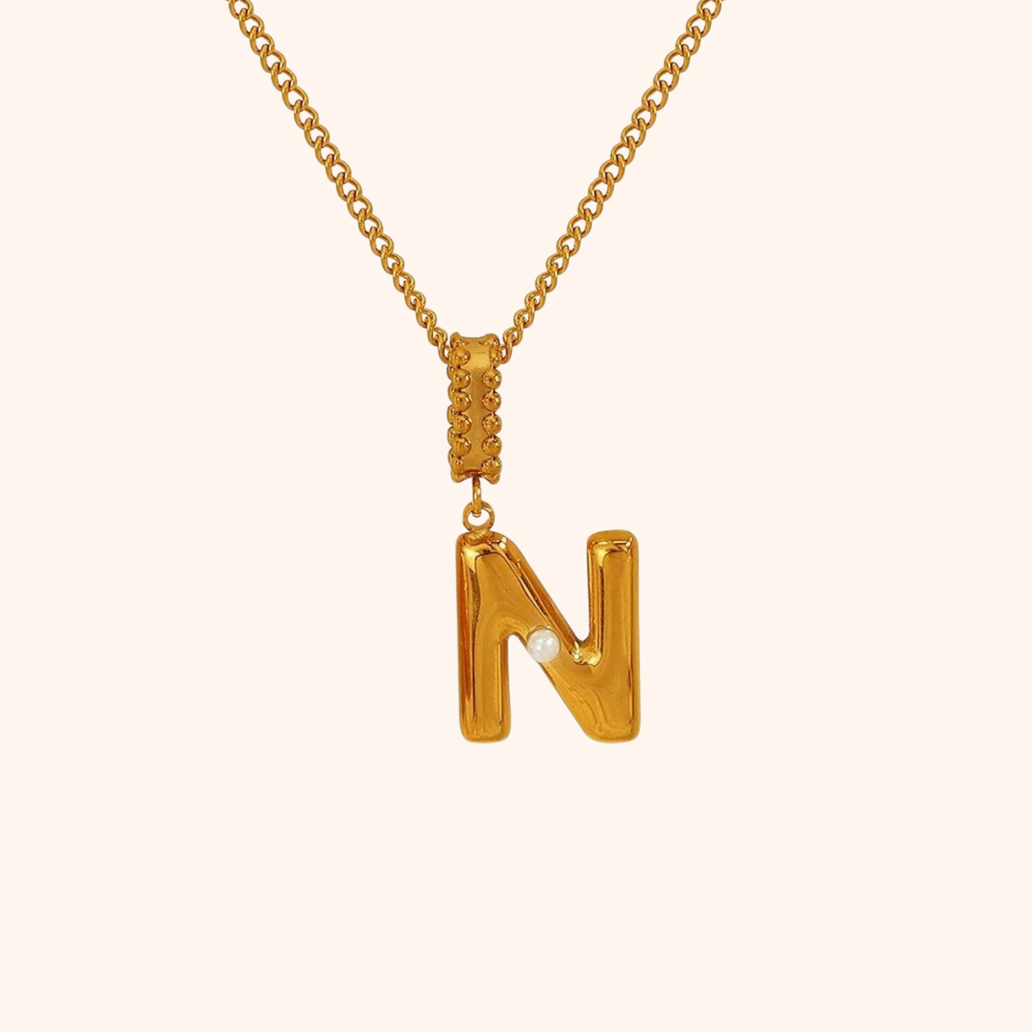 N initial necklace in gold with singular pearl accent